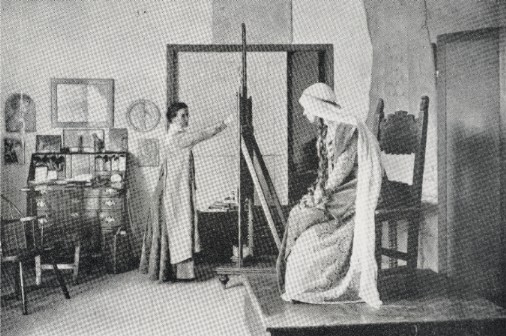 Photograph of Elizabeth Shippen Green at work
                in her studio