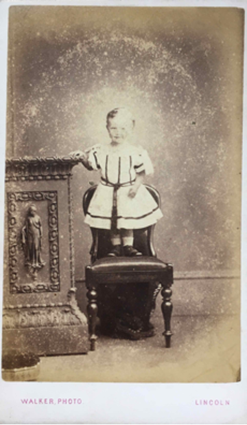 Victorian photography of a toddler standing on a chair
